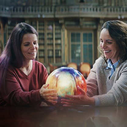 Two sisters sharing a moment holding the touchable memory.